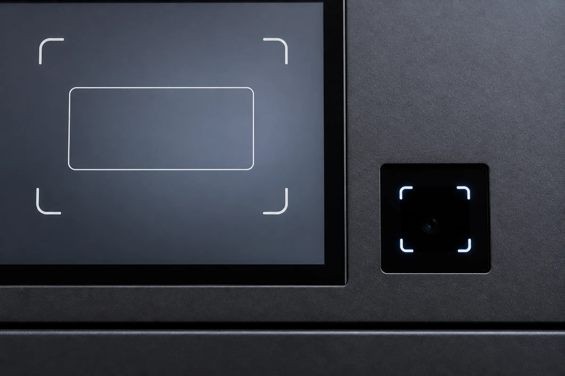Close-up of a vending kiosk screen showing an outlined ID card inside a scan frame, with the small dark camera window of the document scanner set into the fascia beside it.